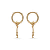 Pair of gold hoop earrings with dangling elements on a white background