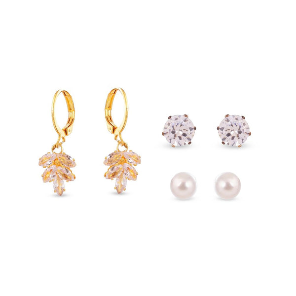 Set of gold earrings with floral designs, silver stud earrings, and pearl earrings on a white background