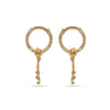 Pair of gold hoop earrings with dangling elements on a white background
