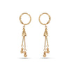 Pair of gold earrings with dangling elements on a white background